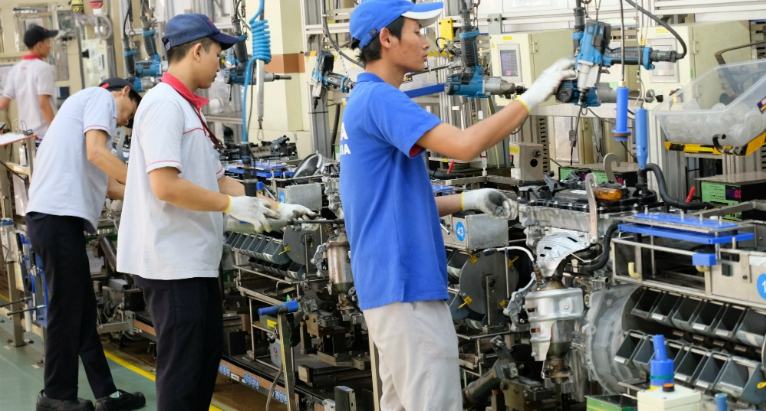 Assembly line workers at machines